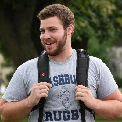 Student smiles while walking to class